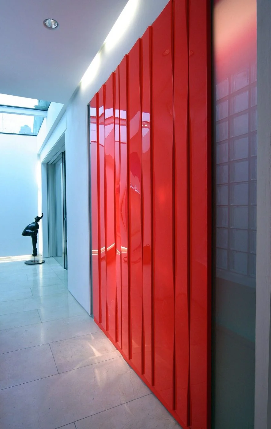 Chromatic — high-gloss fluorescent red lacquer linear panel system, penthouse Central London, Sterox Studio